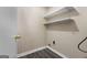 This is the laundry room with white shelves and wood flooring at 632 Cloudland Dr, Stockbridge, GA 30281