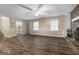 This living room has wood flooring, two windows, and a stone fireplace at 632 Cloudland Dr, Stockbridge, GA 30281