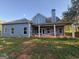Rear view of this lovely home featuring a covered patio at 808 Covered Bridge Rd, Covington, GA 30016