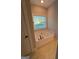 Bathroom with a bathtub below a window at 808 Covered Bridge Rd, Covington, GA 30016