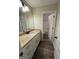 Bathroom with a single sink vanity, granite countertops and wood-like floors at 808 Covered Bridge Rd, Covington, GA 30016