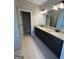 Bathroom with a double sink vanity, granite countertops and tiled floors at 808 Covered Bridge Rd, Covington, GA 30016