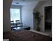 Bedroom featuring a large window, chairs, and a walk-in closet at 808 Covered Bridge Rd, Covington, GA 30016