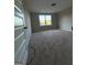 Bedroom featuring neutral paint, carpet, and a window with outside views at 808 Covered Bridge Rd, Covington, GA 30016