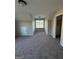 Carpeted bonus room featuring a window, storage closet, and neutral paint at 808 Covered Bridge Rd, Covington, GA 30016
