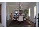 Formal dining room with wainscotting, chandelier, and large windows at 808 Covered Bridge Rd, Covington, GA 30016