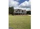 Charming two-story home with blue siding, white trim, a well-manicured lawn and landscaping at 808 Covered Bridge Rd, Covington, GA 30016