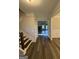 Inviting foyer featuring hardwood floors, a staircase, and views into the living area at 808 Covered Bridge Rd, Covington, GA 30016