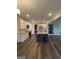 Bright kitchen with white cabinets, island with seating, and stainless steel appliances at 808 Covered Bridge Rd, Covington, GA 30016