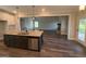 Open kitchen with granite countertops, stainless steel appliances, and a view of the living area at 808 Covered Bridge Rd, Covington, GA 30016