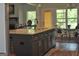 Kitchen island with seating adjacent to a dining area and fireplace at 808 Covered Bridge Rd, Covington, GA 30016