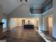 Bright living room with hardwood floors, fireplace, and open floor plan into the kitchen at 808 Covered Bridge Rd, Covington, GA 30016