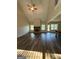 Living Room featuring a vaulted ceiling, hardwood floors, a fireplace and ample sunlight at 808 Covered Bridge Rd, Covington, GA 30016
