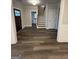 Spacious living room with hardwood floors, a staircase, and views into other rooms at 808 Covered Bridge Rd, Covington, GA 30016