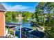 Aerial view of lake house showcasing lush greenery, the serene lake, and neighborhood docks at 1295 Heritage Dr, Villa Rica, GA 30180