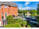 Backyard view of lakeside home with deck, lake views, brick exterior, and lush greenery at 1295 Heritage Dr, Villa Rica, GA 30180