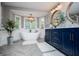 Spacious bathroom featuring a tub, double sink vanity, modern lighting, and stylish decor at 1295 Heritage Dr, Villa Rica, GA 30180