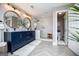Elegant bathroom boasts a navy blue vanity, walk-in shower with white subway tile, and herringbone tile flooring at 1295 Heritage Dr, Villa Rica, GA 30180