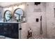 Beautiful bathroom with double sinks, shower, modern lighting, and a large soaking tub surrounded by ample natural light at 1295 Heritage Dr, Villa Rica, GA 30180