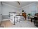 Cozy bedroom with a metal bed frame, wood floors, and decor at 1295 Heritage Dr, Villa Rica, GA 30180
