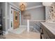Inviting entryway with decorative glass front door, chandelier and a staircase with black wrought iron railing at 1295 Heritage Dr, Villa Rica, GA 30180