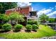 Charming brick home featuring a spacious deck, well-manicured lawn, and mature landscaping at 1295 Heritage Dr, Villa Rica, GA 30180
