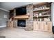 Living room with a stone fireplace, built-in shelves, cabinets, and hardwood floors at 1295 Heritage Dr, Villa Rica, GA 30180