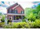 Charming brick two-story home with a welcoming front porch and well-maintained landscaping at 1295 Heritage Dr, Villa Rica, GA 30180