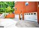 Spacious three-car garage with white doors and an adjacent entrance, framed by a well-kept lawn at 1295 Heritage Dr, Villa Rica, GA 30180