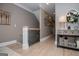 Hallway with light wood floors and neutral walls, featuring stylish decor and access to multiple areas of the home at 1295 Heritage Dr, Villa Rica, GA 30180