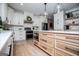 Bright kitchen boasts stainless steel appliances, white cabinets and a light wood island with quartz countertops at 1295 Heritage Dr, Villa Rica, GA 30180