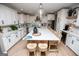 Bright kitchen features a large quartz island with wine fridge, bar seating, and stainless steel appliances at 1295 Heritage Dr, Villa Rica, GA 30180