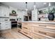 Bright kitchen boasts stainless steel appliances, white cabinets and a light wood island with quartz countertops at 1295 Heritage Dr, Villa Rica, GA 30180
