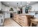 Bright kitchen boasts stainless steel appliances, white cabinets and a light wood island with quartz countertops at 1295 Heritage Dr, Villa Rica, GA 30180
