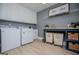 Well-organized laundry room with white cabinetry, modern machines, and a folding table for added convenience at 1295 Heritage Dr, Villa Rica, GA 30180