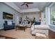 Well-lit living room with a view, a large area rug, and comfortable stylish couches at 1295 Heritage Dr, Villa Rica, GA 30180