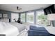 Bright primary bedroom with a lake view from the windows, a sitting area, and a stationary exercise bike at 1295 Heritage Dr, Villa Rica, GA 30180