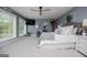 Serene primary bedroom with soft blue walls, a cozy sitting area, and large windows providing natural light at 1295 Heritage Dr, Villa Rica, GA 30180