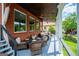 Picturesque porch with brick siding, outdoor seating, and lush greenery at 1295 Heritage Dr, Villa Rica, GA 30180