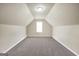 Spacious bonus room featuring neutral paint, carpet, and bright natural light from window at 502 Gallantry Trl, Mcdonough, GA 30252