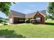 Classic brick home featuring shuttered windows and lush landscaping on a sunny day at 502 Gallantry Trl, Mcdonough, GA 30252