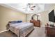 Spacious main bedroom with a tray ceiling, dresser and a large window at 502 Gallantry Trl, Mcdonough, GA 30252