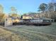 Large backyard showcasing the house's deck, grassy yard, and mature trees at 110 Kari Glen Way, Fayetteville, GA 30215