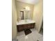 Neutral-toned bathroom featuring a vanity with wooden cabinets and a large mirror at 110 Kari Glen Way, Fayetteville, GA 30215