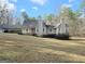 Charming home featuring a covered front porch, complemented by mature trees and landscaping at 110 Kari Glen Way, Fayetteville, GA 30215