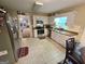 Bright kitchen features white cabinets, stainless steel appliances, and a view into the living room at 110 Kari Glen Way, Fayetteville, GA 30215