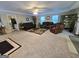 Spacious living room features a ceiling fan, carpet floors and ample natural light at 110 Kari Glen Way, Fayetteville, GA 30215