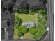 An aerial view shows a home with a well-manicured lawn and mature trees bordering the property at 105 Birch Creek Cir, Mcdonough, GA 30253