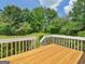 Wooden deck overlooking lush landscaping, green grass, and mature trees, making it the perfect retreat at 105 Birch Creek Cir, Mcdonough, GA 30253