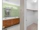 Bright bathroom featuring dual sinks, wood cabinetry, large mirror, and a walk-in closet for extra storage at 105 Birch Creek Cir, Mcdonough, GA 30253